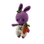 Mor renkli amigurumi tavşan bebek stand üzerinde dik duruş pozisyonu beyaz tulumlu